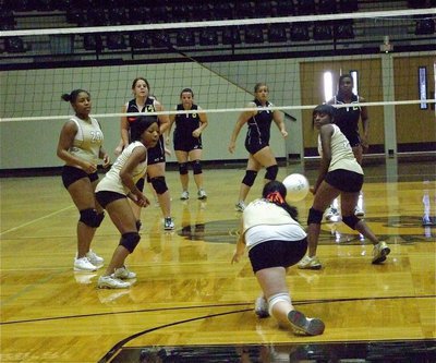 Image: Can you dig it? — Paige Westbrook executes a dig to give her teammates Ashley Harper, Ryisha Copeland and Kendra Copeland a chance.