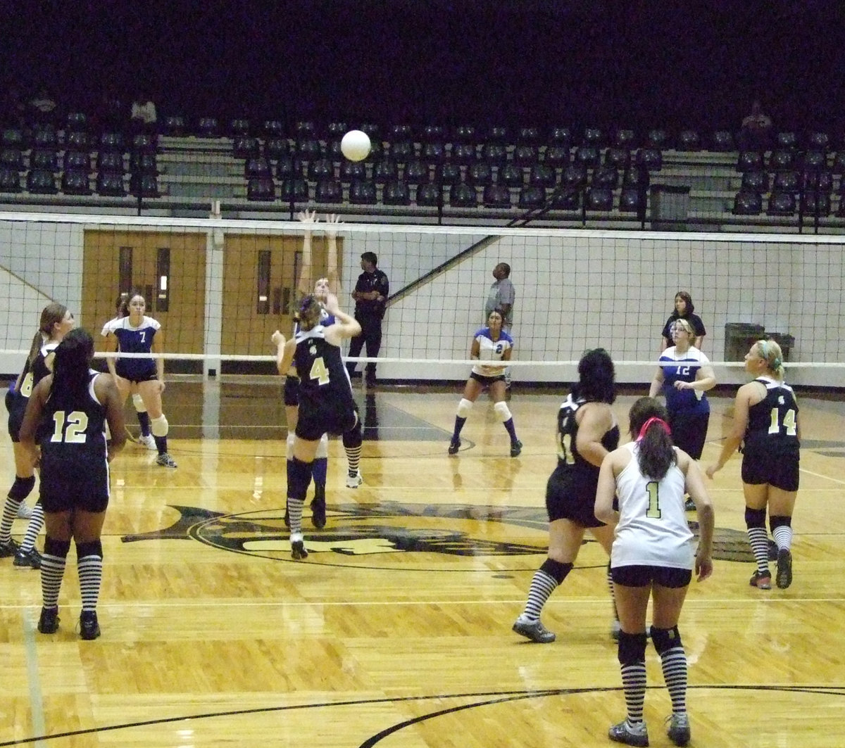 Image: Windham jumps — Junior, Drew Windham, volleys back.