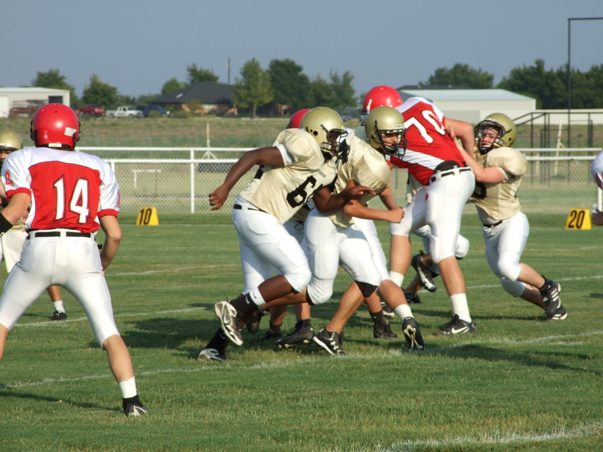 Image: The Clash — Adrian Reed(64) Cody Medrano(75) and Jake Escamilla(66) and in there somewhere is center Bailey Walton(52) did a masterful job on Thursday controlling the line of scrimmage.