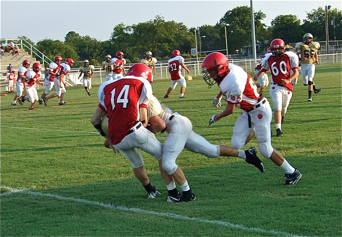 Image: Hamilton’s big hit — Chase Hamilton(10) separates a Panther return man from the ball. Italy’s Eric Carson(28) recovered the resulting fumble that setup another JV Gladiator touchdown.