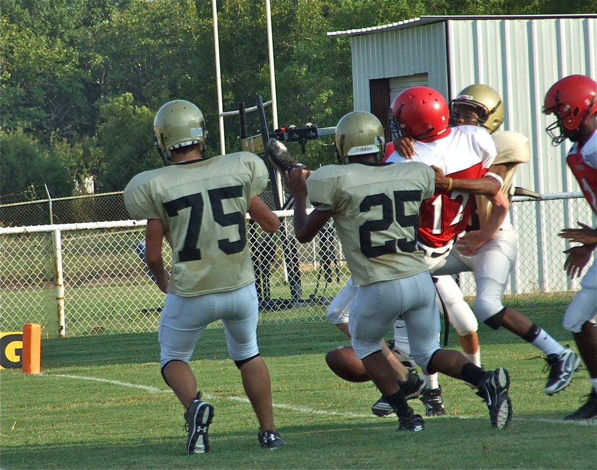 Image: Blocked punt — Cody Medrano(75) and Mike Clark(25) disrupt the Panther punter’s rhythm and Eric Carson(28) wraps him up before he can kick the ball away. Italy recovered the ball on Maypearl’s 4-yard line.