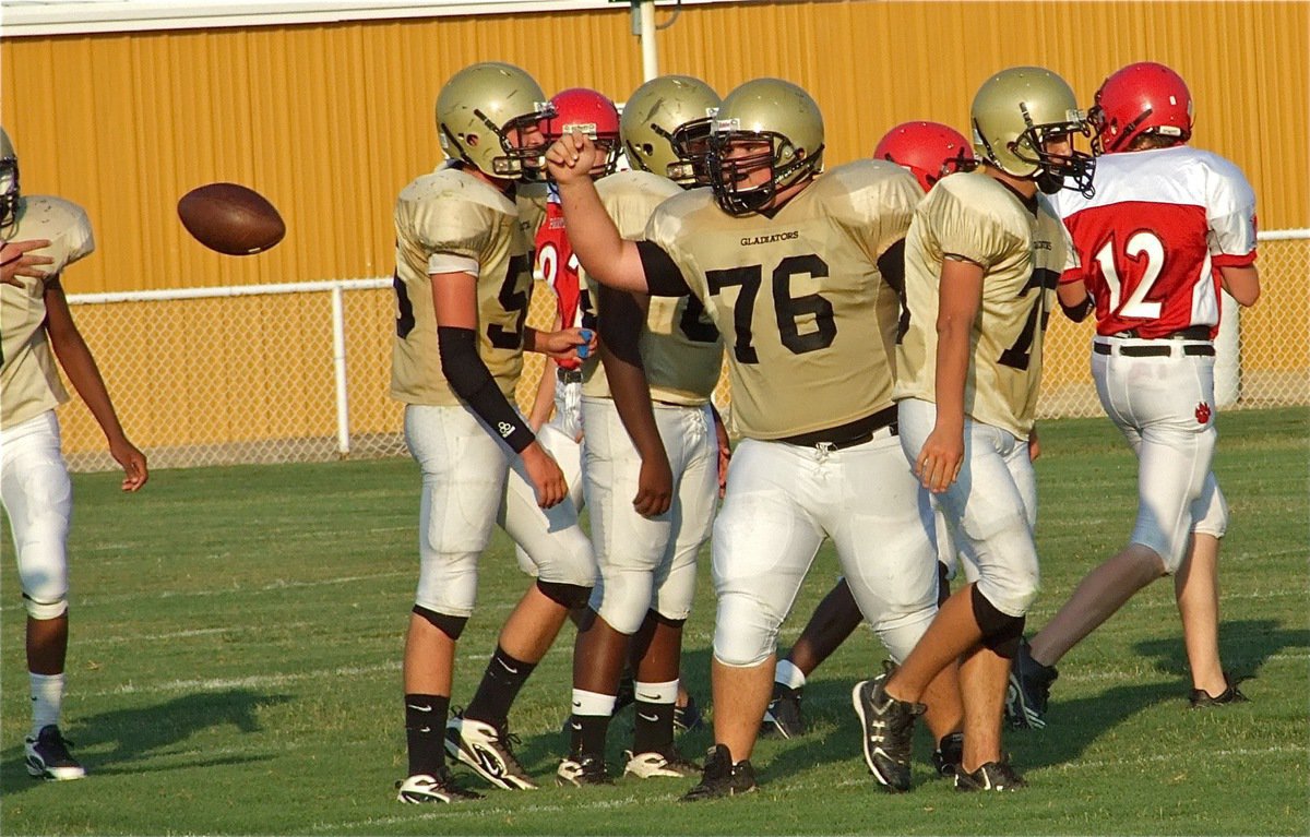 Image: “Big Time” play! — Hank “Big Time” Seabolt(76) makes a big play by recovering a fumble for the JV Gladiators and flips it over to Mr. Referee.