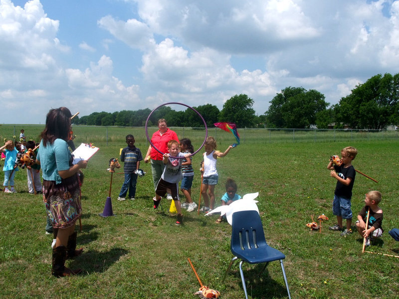 Image: Trying Hard — Teachers watch as the students try very hard to rope the bull.