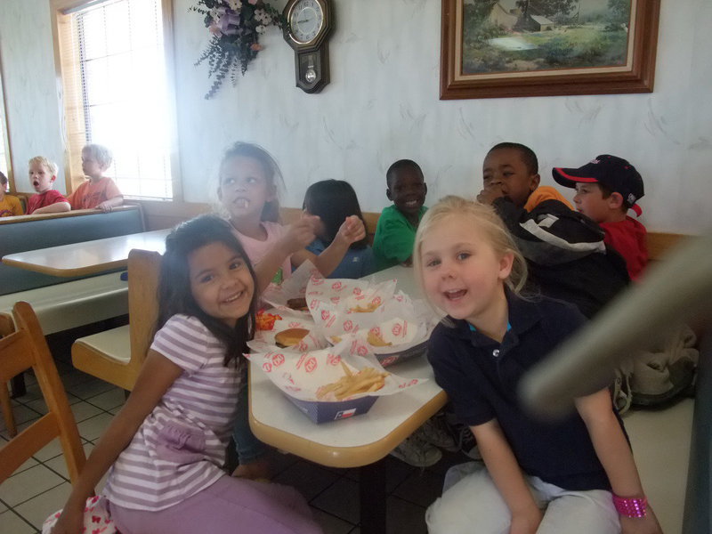 Image: Let’s Eat — These little ones are happily eating their hamburgers and fries.