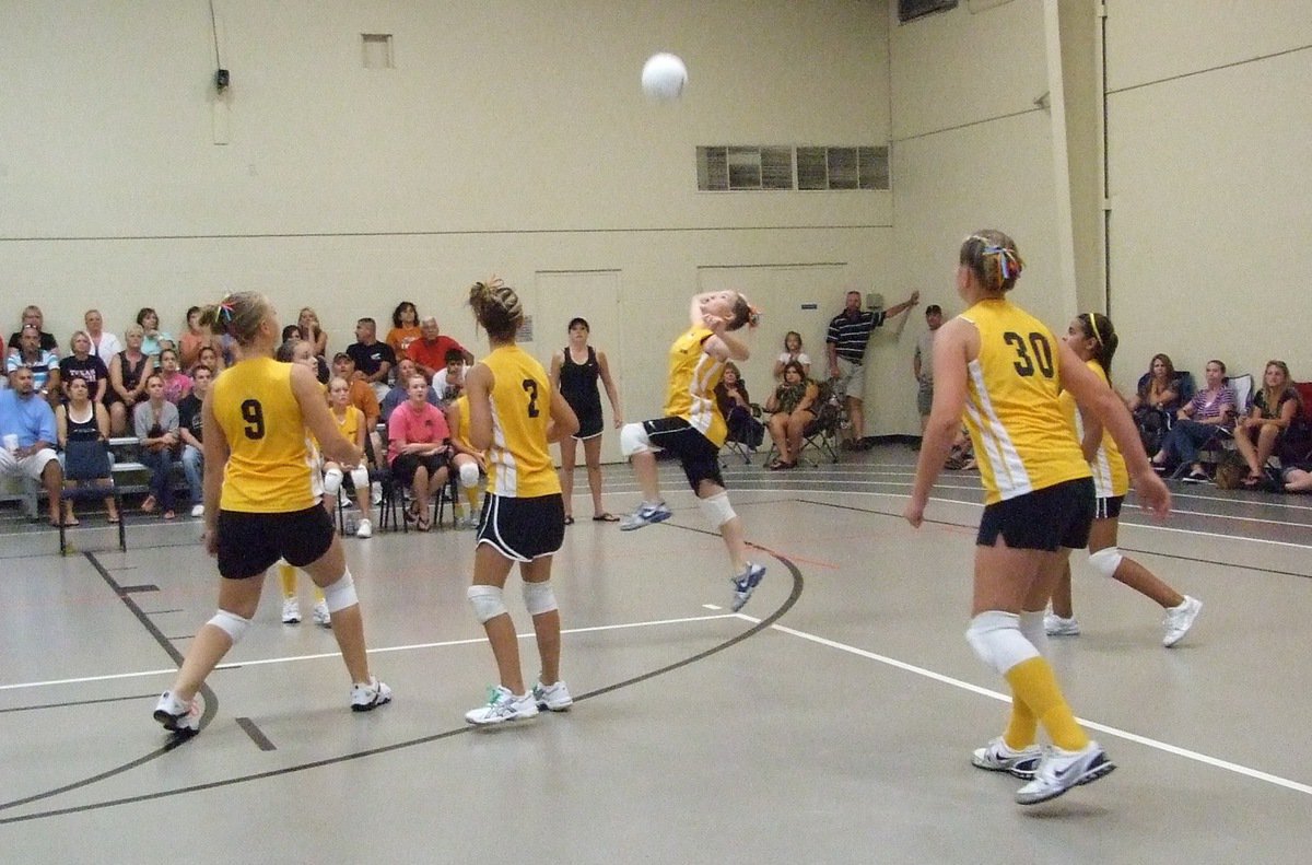 Image: Tara Wallis leaps for a one-handed return in the Championship — Italy’s defense relied on their athleticism to reach the YMCA’s Volleyball Tournament Championship game for 7th and 8th Grade girls.