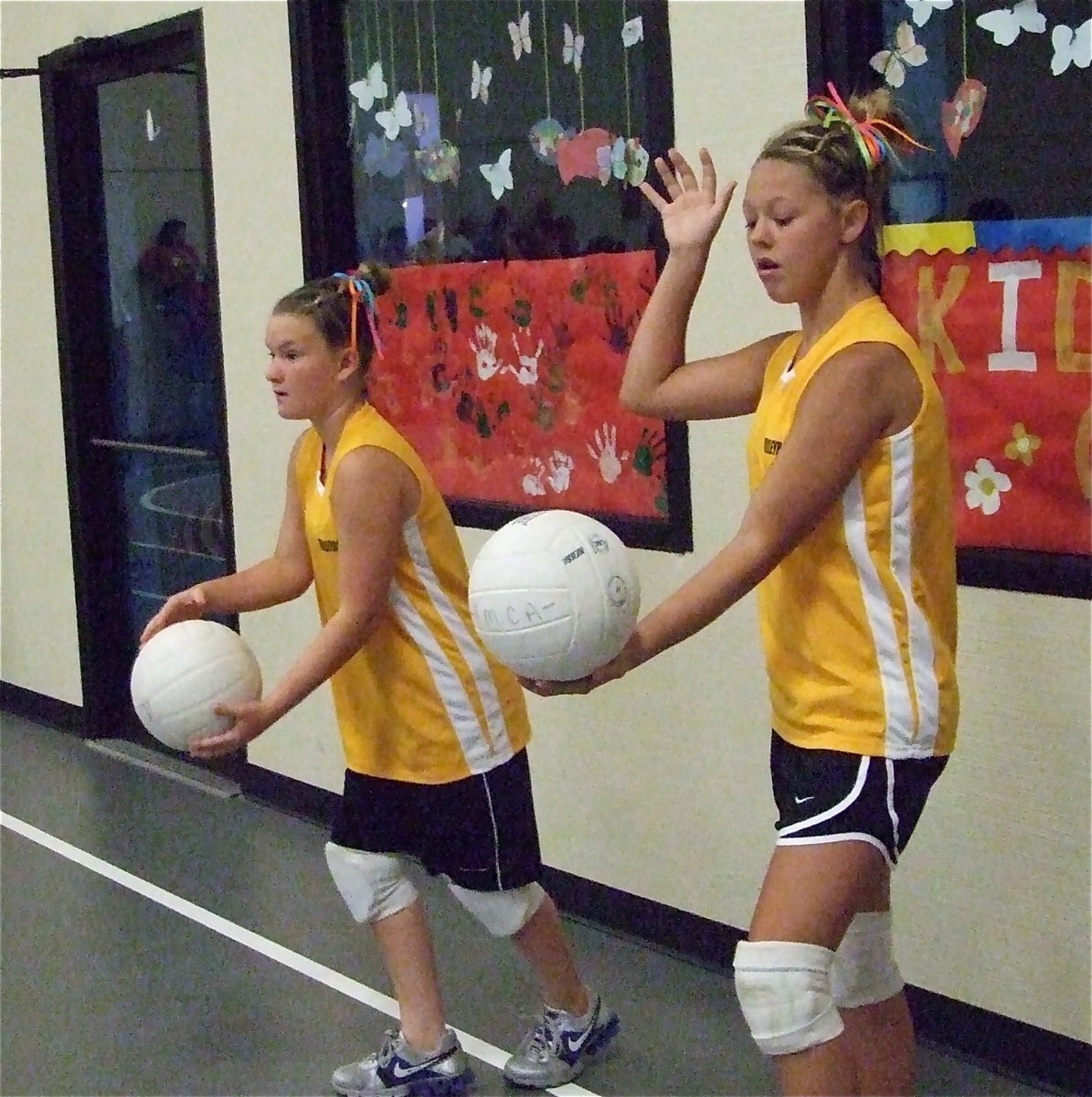 Image: Serving up wins — Tara Wallis and Bailey Eubank practice their serves before their round two match against Waxahachie. Italy eventually won both sets.