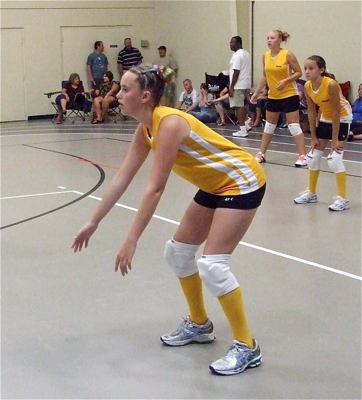 Image: Kelsey’s ready — Kelsey Nelson, Jozie Perkins and Jaclynn Lewis get ready for the serve.