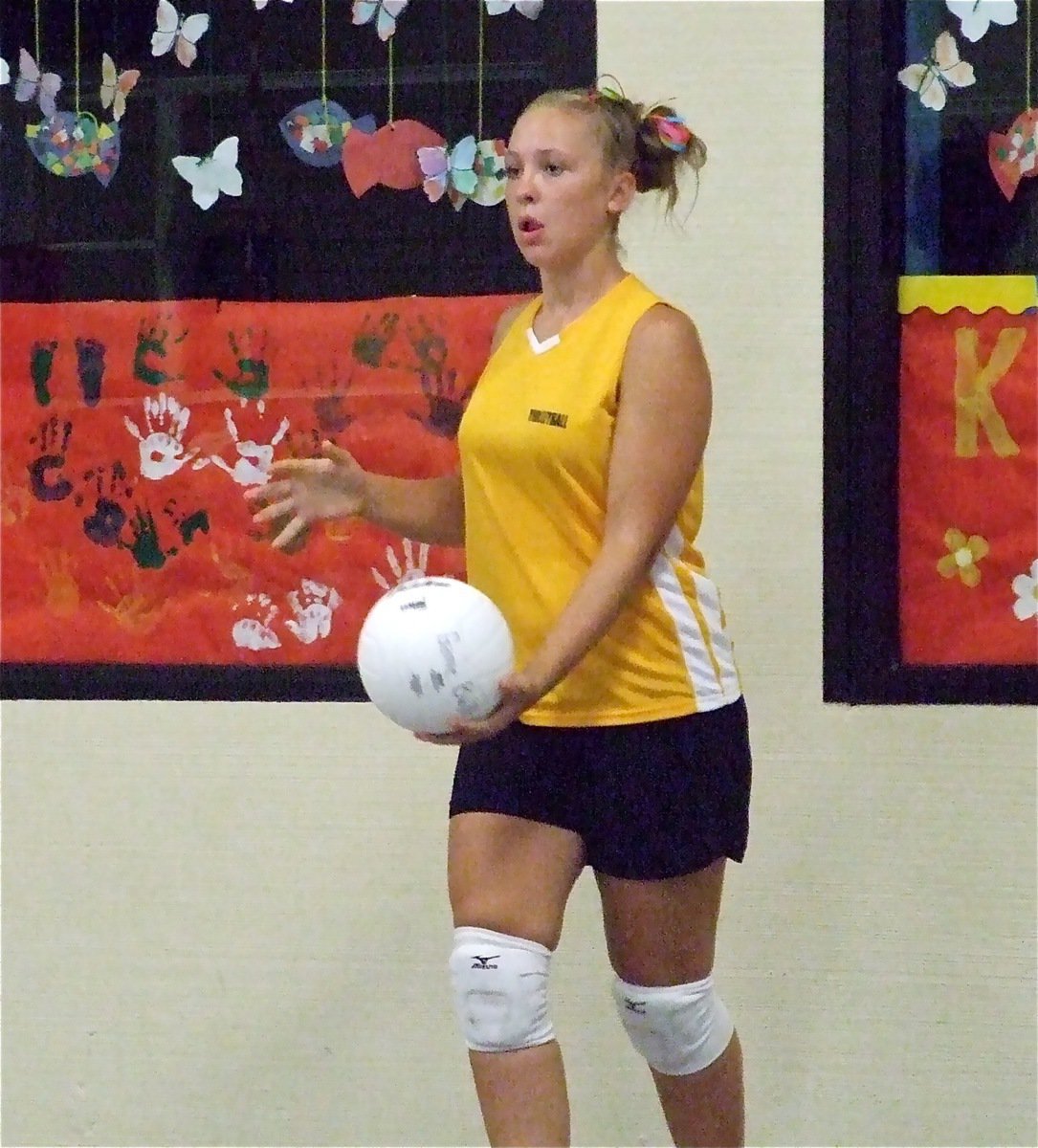 Image: Going for it — Jaclynn Lewis prepares to serve against Waxahachie.