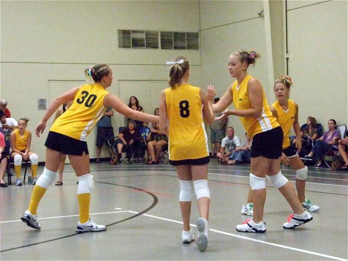 Image: Celebrating a point — Madison Washingon(30), Hannah Washington(8), Jaclynn Lewis and Bailey Eubank congratulate one another on earning a point.