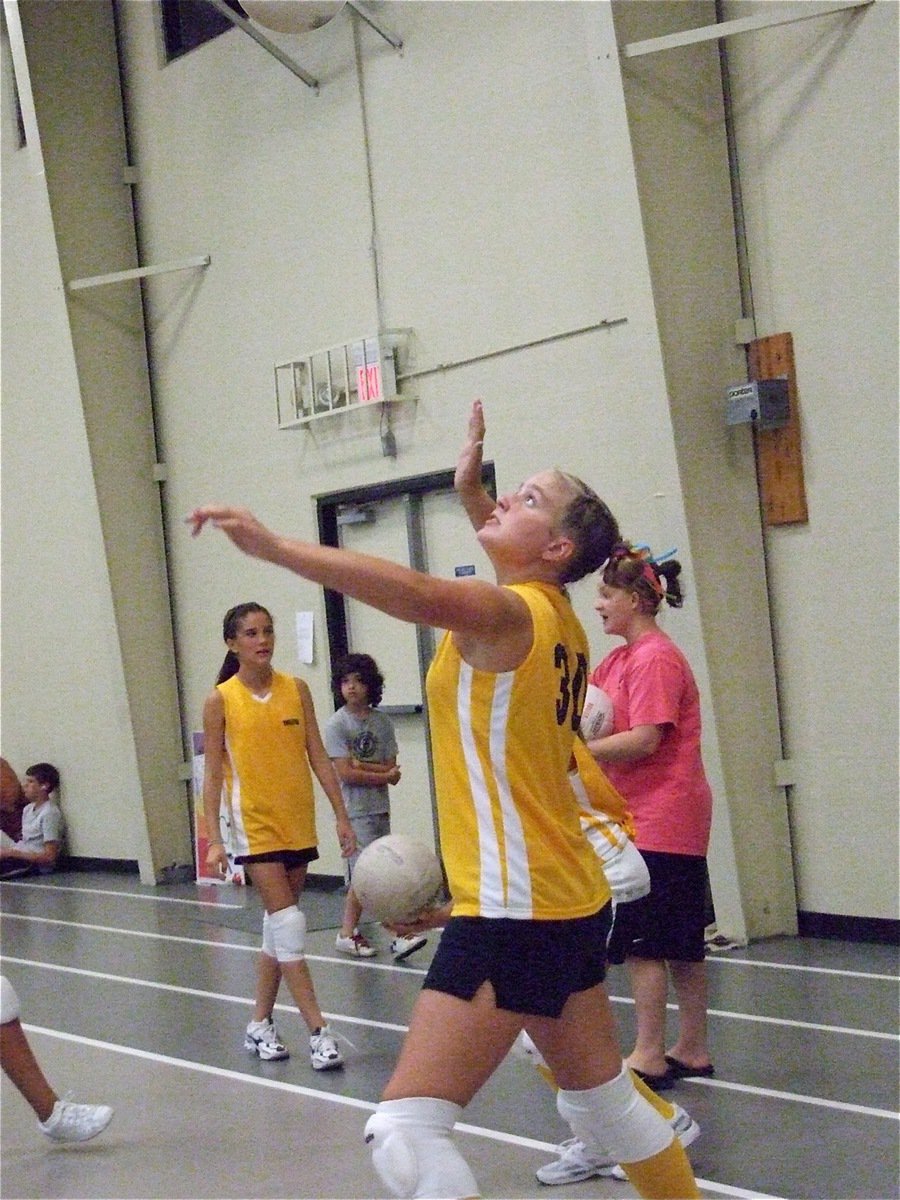 Image: Warning! — Madison Washington takes a practice serve before the championship game against Maypearl.