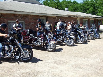 Image: The dismount — Members of the Southern Cruisers Riding Club of Ellis County 326 parked in front of Mama’s Place on Sunday in Italy to prepare for the cleanup.