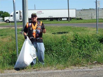Image: Thumbs up! — Shay Krnavek gives a thumbs up during the cleanup.