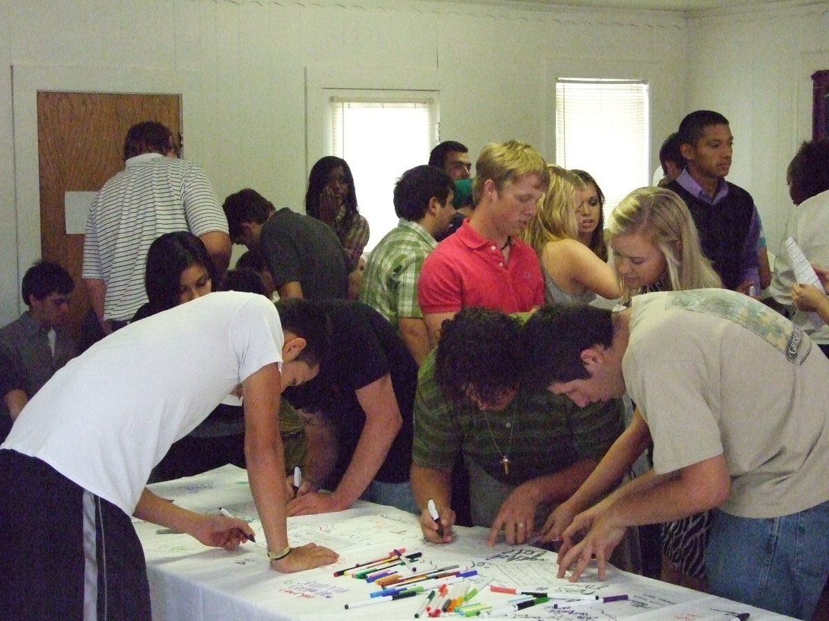 Image: Sign the sheet — The graduating seniors were given markers and a white sheet.  That’s not a messy thing.  They will actually preserve this for future