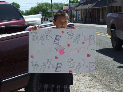Image: Bake Sale! — Josh Valdez encourages passersby to pull in and buy baked goods on behalf of the Avalon Baptist Church’s fund raising effort to help send 24 kids to church camp.
