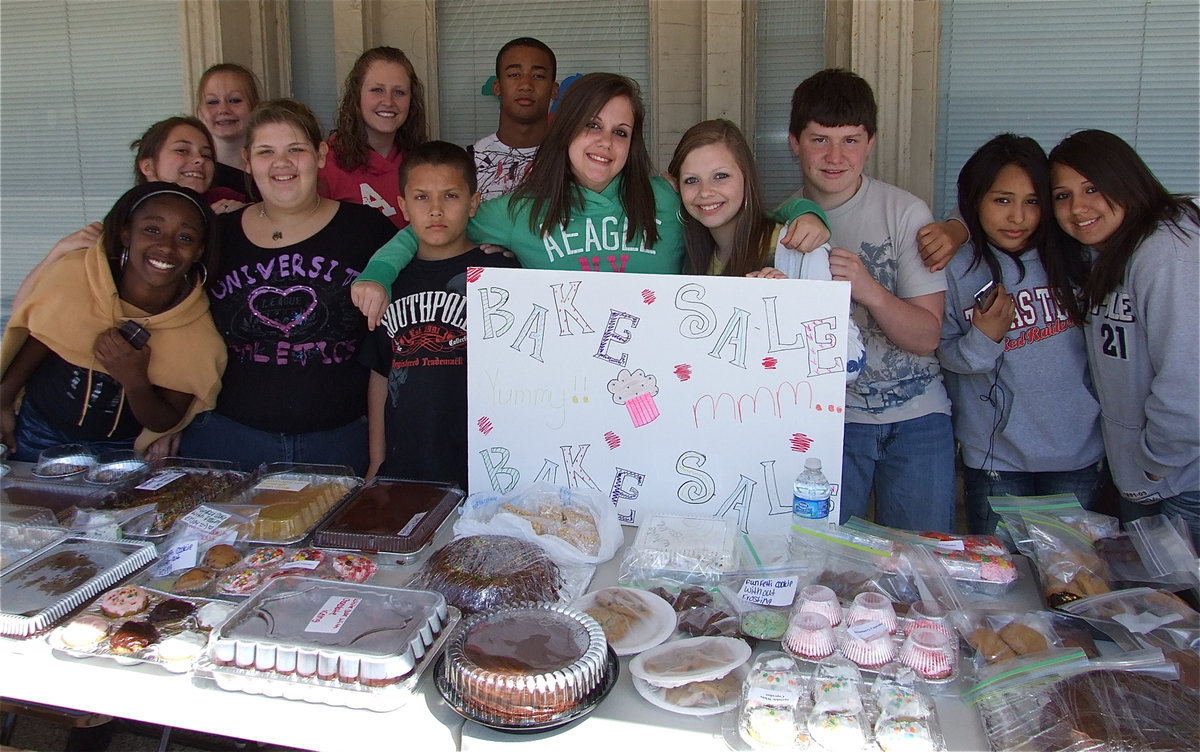 Image: Baking for Jesus — Ra’Gene Miles, Caitlin Alewine, Emma Presley, Mallory Valdez, Mikella Wimbish, Josh Valdez, Denzel Murray, Ella Presley, Kaitlyn Harrison, Jake Escamilla, Cheyenne Lara and Marie Capata help out during the Avalon Baptist Church Bake Sale in downton Italy.