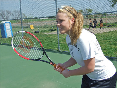 Image: Lethal weapon — Shelbi Gilley pulls a racket from her back for a surprise attack.