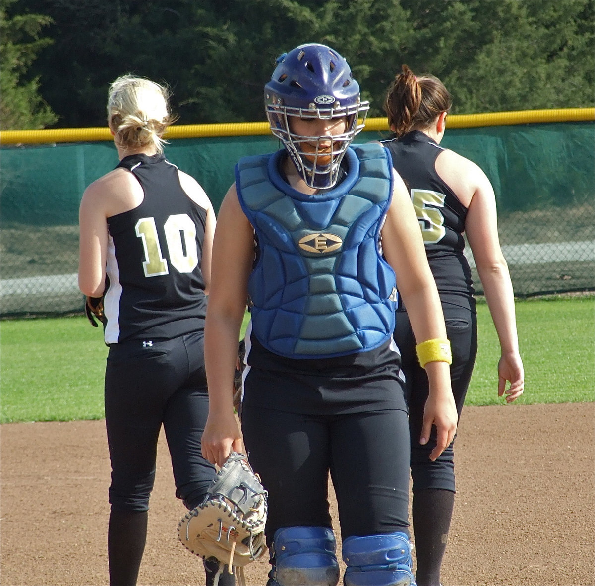 Image: Let’s get it done — Catcher Alyssa Richards heads back behind he plate after chatting with pitcher Courtney Westbrook(10) and 2nd baseman Cori Jeffords(15).