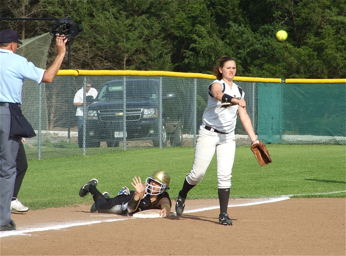 Image: Time! — Alyssa Richards calls for a timeout after sliding into third base. Richards eventually crossed home plate for Italy’s first score of the game.