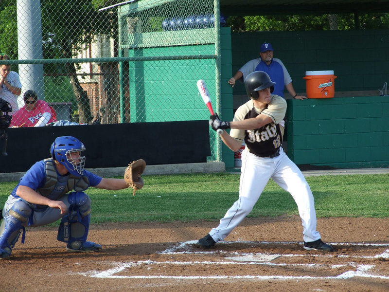 Image: Ashcraft is up — Catcher Ryan Ashcraft aims for the outfield.  He said, “After an emotional loss last year, it is good to come back and win it.  We are the best team in our district.”