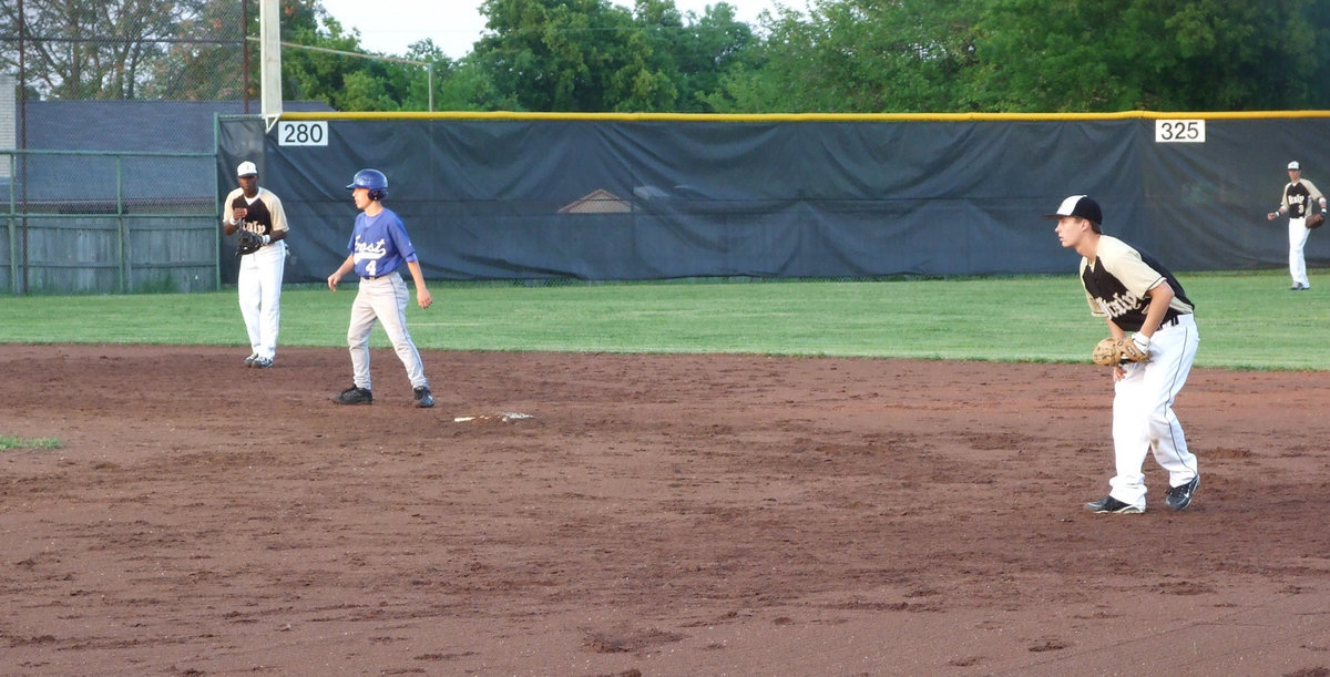 Image: Anderson and Patterson — Jasenio and Trevor guard Frost to keep from scoring.