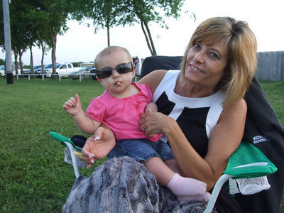 Image: Italy’s youngest fan — Avery Gage sits with “Nana” Ramona Simon and enjoys french fries and Italy baseball.