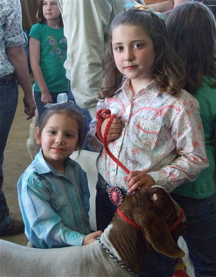 Image: Ella and Lani — Lani helps Ella with her lamb during Junior Showmanship. Ella got her ribbon and was ready to do it again!