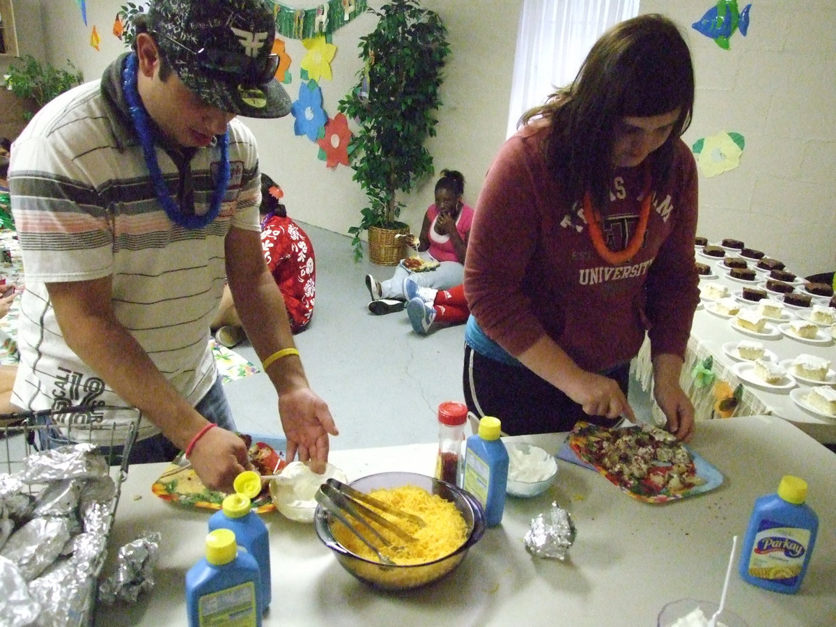 Image: Load it up — Alejandro Tapia and Meredith Brummett stop at the potato bar for all the fixins’.