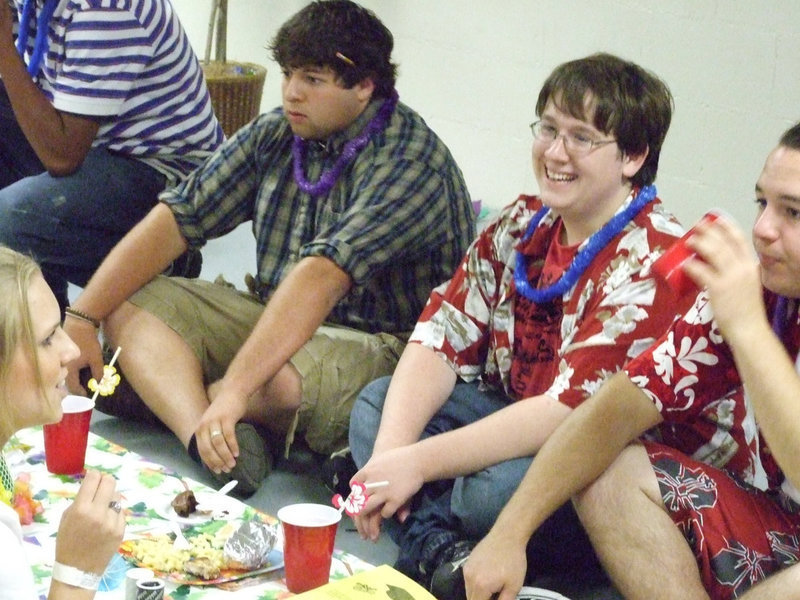 Image: What’s so funny — Brandon Owens sits with Ivan Roldan and Zach Hernandez as they visit with Megan Hopkins.