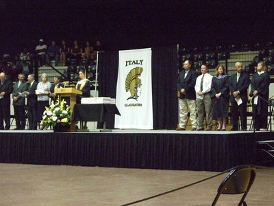 Image: Distinguished guests — Faculty and school board members grace the stage for graduation.