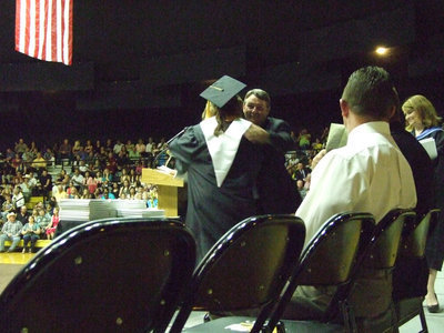 Image: The honors were given — School board member, Larry Eubank, helps Ms. Parker give the graduates their certificates.