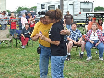 Image: Ribbon and a hug — Melissa Souder congratulates Jason Escamilla on his accomplishment during the BBQ cook-off awards presentation.