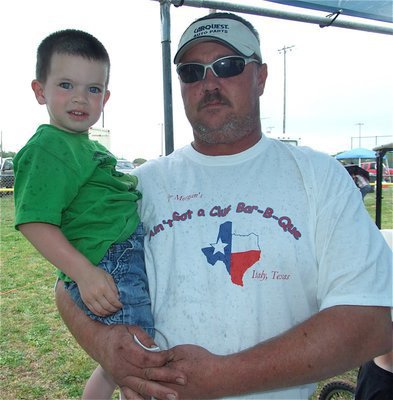 Image: Big winner — Brian Morgan of “Ain’t Got a Clue Bar-B-Que” holds little Austin Cate who had a big day winning a laptop during the raffle.