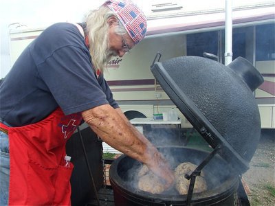 Image: Royce Williams — Royce Williams, a former V.P. of the Lone Star BBQ Society, arranges his chickens on a 1976 Japanese grill that will cook the chickens in half the time that it takes american grills, claims Williams.