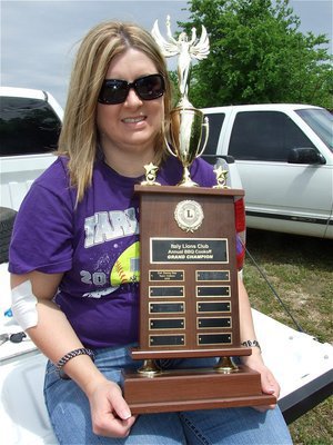 Image: It’s our, “Day!” — Cindy Reed displays the traveling Grand Championship trophy (Local winners only) that was won by Danny Day and his team called the Outlaws during the 1st Annual Italy Lions Club cook-off. Danny’s son Peyton Day, and his cooking team called the Convicts, won the trophy this year. Good luck to Danny Day who is currently running for the Italy School Board.