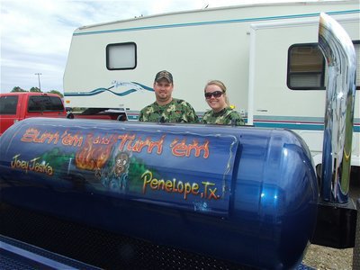 Image: Now that’s a grill! — Joey Jaska and Jessica Barber from Penelope, Texas know how to, “Burn ’em and Turn ’em.”