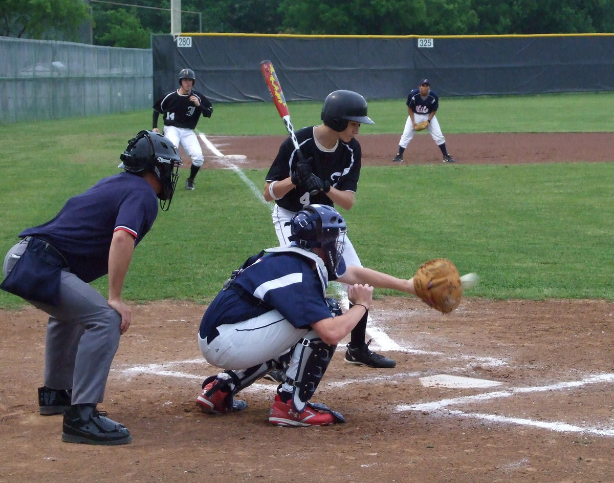 Image: Watchin’ it all the way — Alex DeMoss watches the ball and waits for the right moment.  Clint Gatling waits patiently to come home for the score.