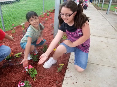 Image: We are Proud! — These two second graders are proud of their flowers.