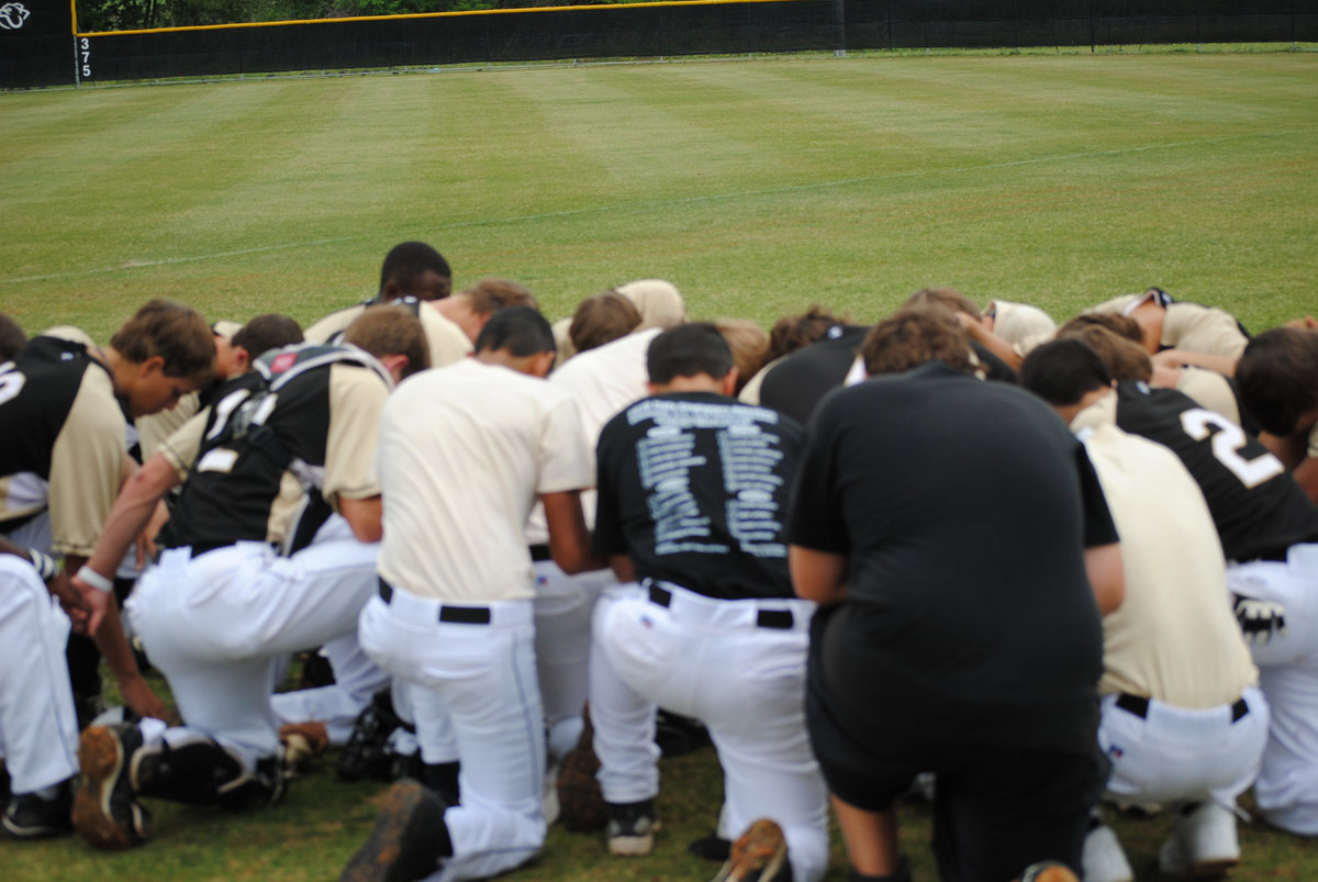 Image: A moment of silence — The Gladiators bow their heads for a moment.