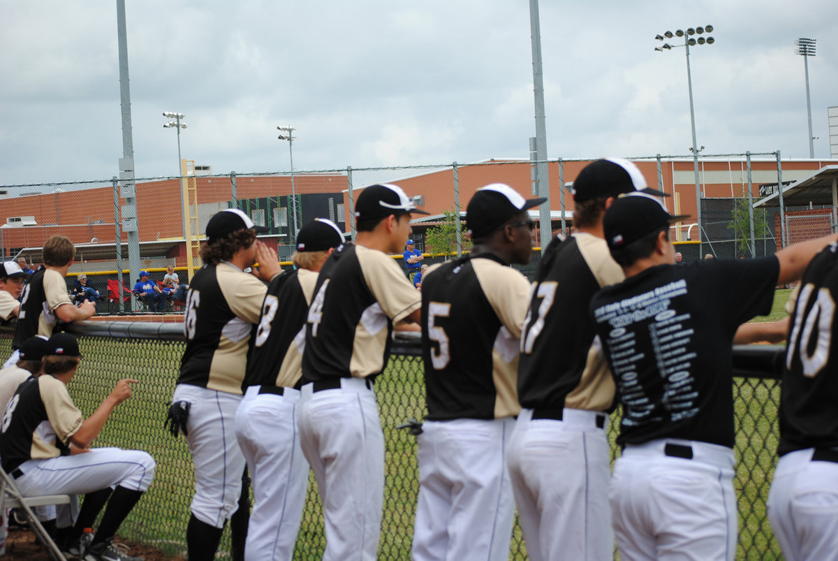 Image: What’s happening — The guys lean on the fence and each other.