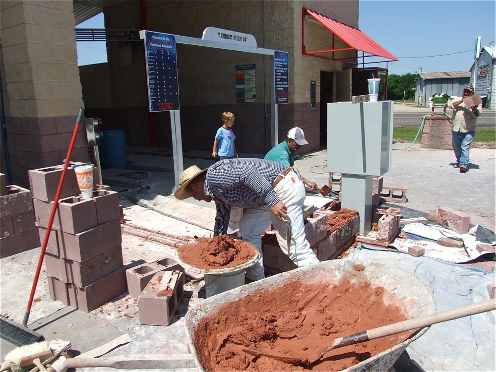 Image: Creighton’s the boss — Creighton Hyles oversees the construction outside the Water Wizard bay for his dad, Charles.