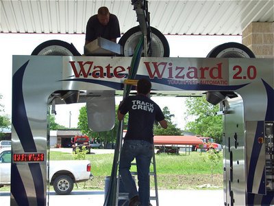 Image: Cleaning crew — C5 Hyles Car Wash owners Christie &amp; Charles Hyles near the end of a 5 year goal that called for installing the Water Wizard in one of his existing bays. Charles even removed some of the previously lain concrete to make the goal a reality.