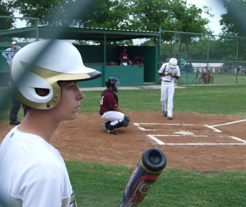 Image: Contemplating — Pitcher Trevor Patterson carefully watches the game.