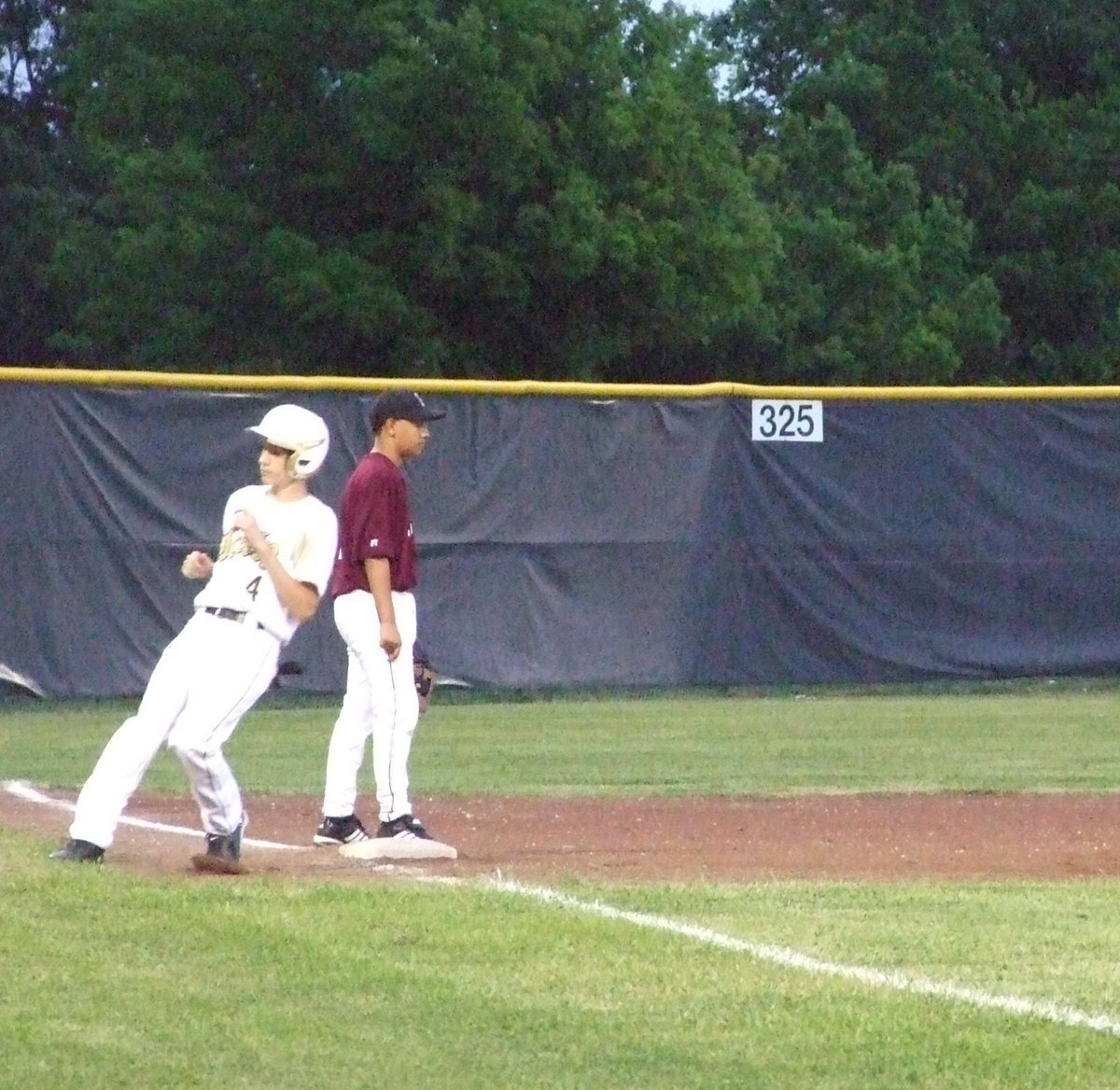 Image: Run to third — Alex DeMoss was hit while batting and took a base.