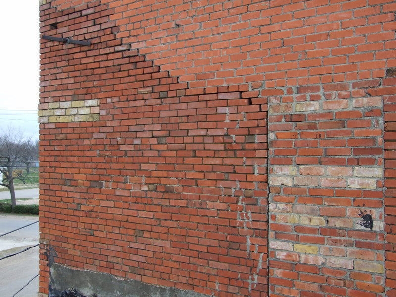 Image: Eroded Mortar — The mortar used on this brick wall has passed its point of usefulness.