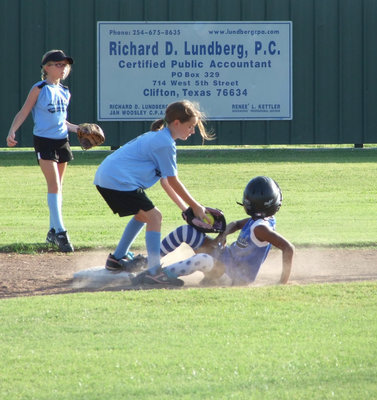 Image: Lindale gets the tag — Milford and Lindale have a battle ‘til the finish Monday night.  Milford’s Jace McIntyre uses her slide.