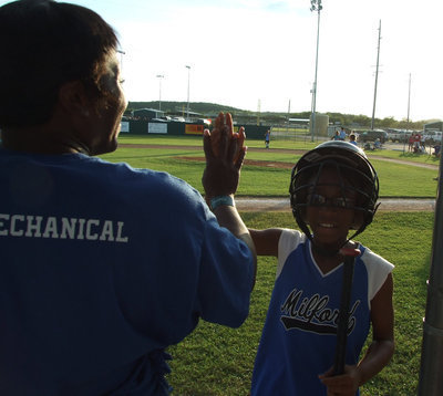 Image: Coach says,“Way to go!” — Coach Veronica Rankin gives a high five to Jace.