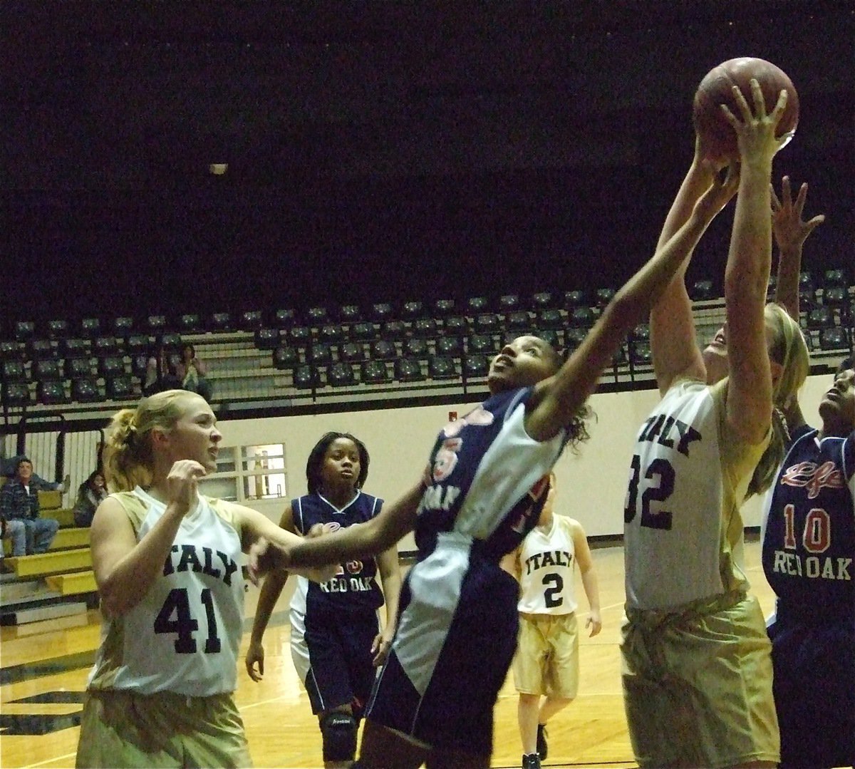 Image: Italy’s 7th Grade Girls pull out a win against Red Oak Life — Italy 7th Grader Madison Washington(32) rips away a rebound against the Red Oak Life Lady Eagles as Jaclynn Lewis(41) lends a hand and Tara Wallis(2) stays back to prevent the fastbreak.