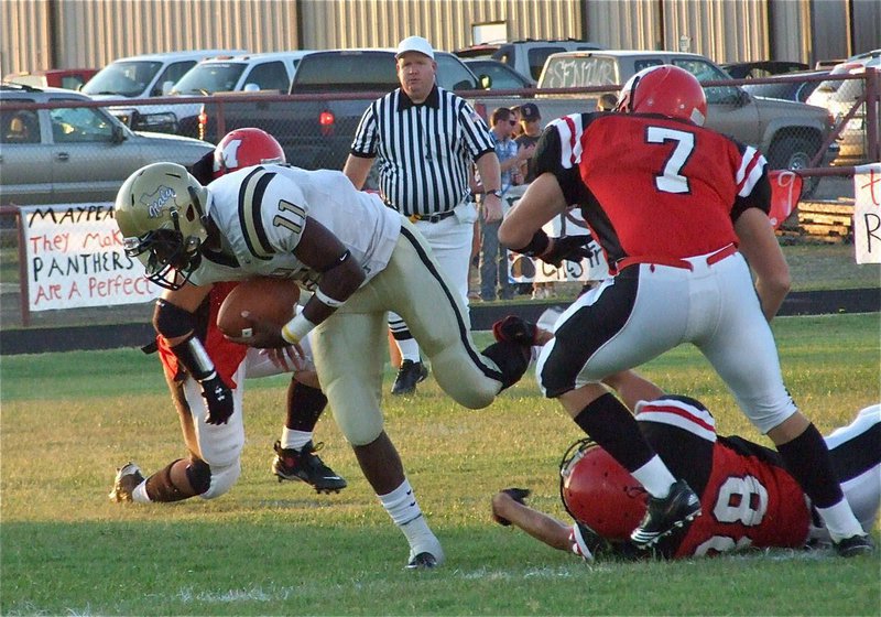 Image: Breaking tackles — Jasenio Anderson(11) sneaks thru the Panther line for valuable yardage.