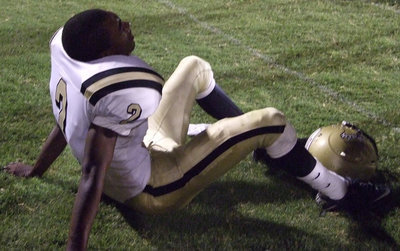 Image: Heath Clemons — Taking a quick break from the game, Clemons #2 rests and works out the cramps.