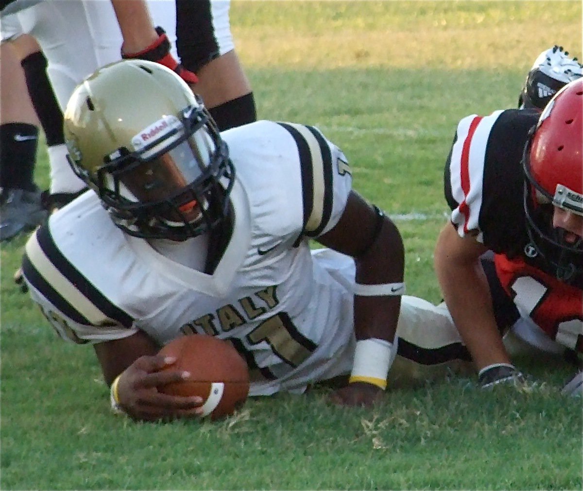 Image: Getting the first — Gladiator quarterback Jasenio Anderson(11) checks the first down marker.